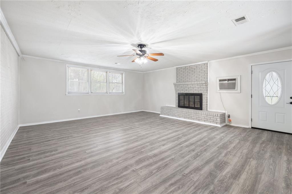 4611 Old Westside Road Austell, GA 30106 - Photo 15 of 37 an empty room with wooden floor ceiling fan and windows