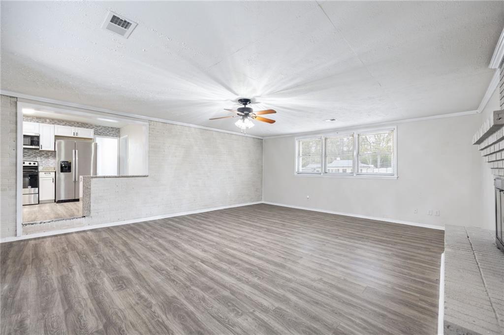 4611 Old Westside Road Austell, GA 30106 - Photo 16 of 37 a view of an empty room with a window and wooden floor