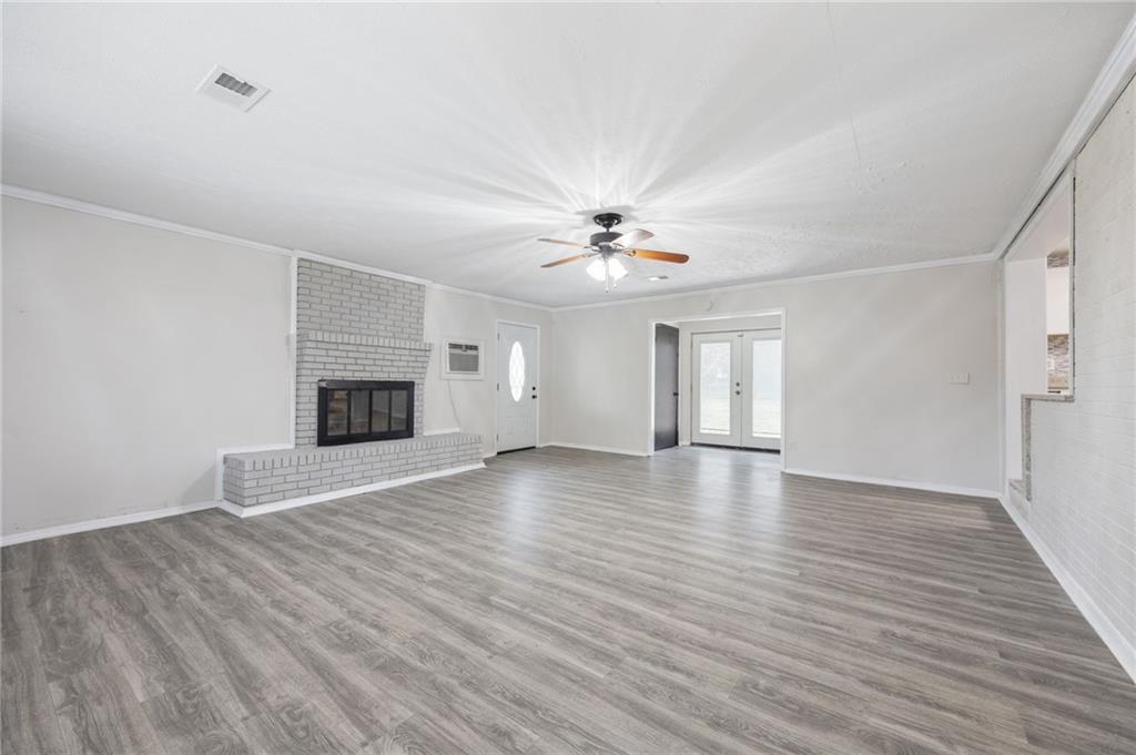 4611 Old Westside Road Austell, GA 30106 - Photo 18 of 37 a view of an empty room with wooden floor and a fireplace