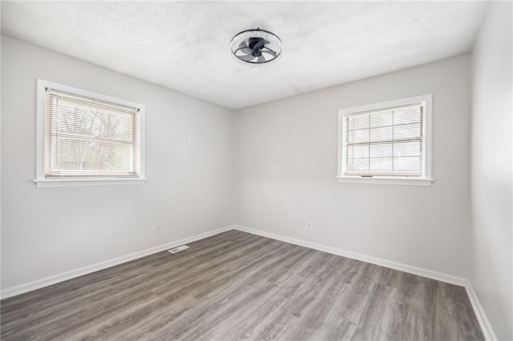 4611 Old Westside Road Austell, GA 30106 - Photo 20 of 37 an empty room with wooden floor and windows