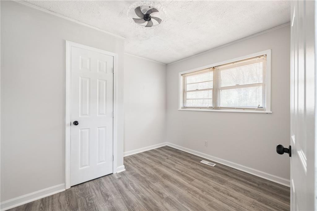 4611 Old Westside Road Austell, GA 30106 - Photo 21 of 37 a view of an empty room with wooden floor and a window