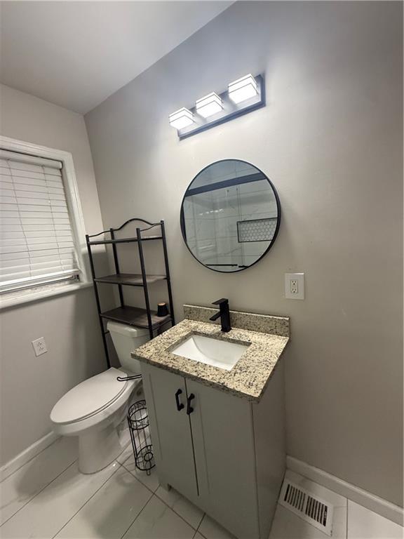 4611 Old Westside Road Austell, GA 30106 - Photo 26 of 37 a bathroom with a toilet a sink and mirror