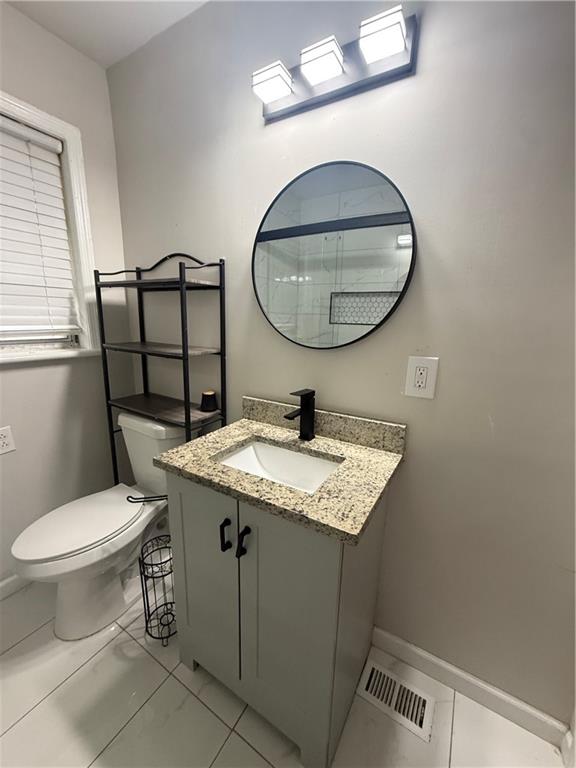 4611 Old Westside Road Austell, GA 30106 - Photo 27 of 37 a bathroom with a granite countertop toilet sink and mirror