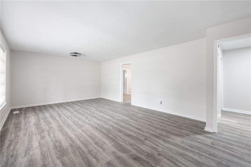 4611 Old Westside Road Austell, GA 30106 - Photo 8 of 37 an empty room with wooden floor and windows