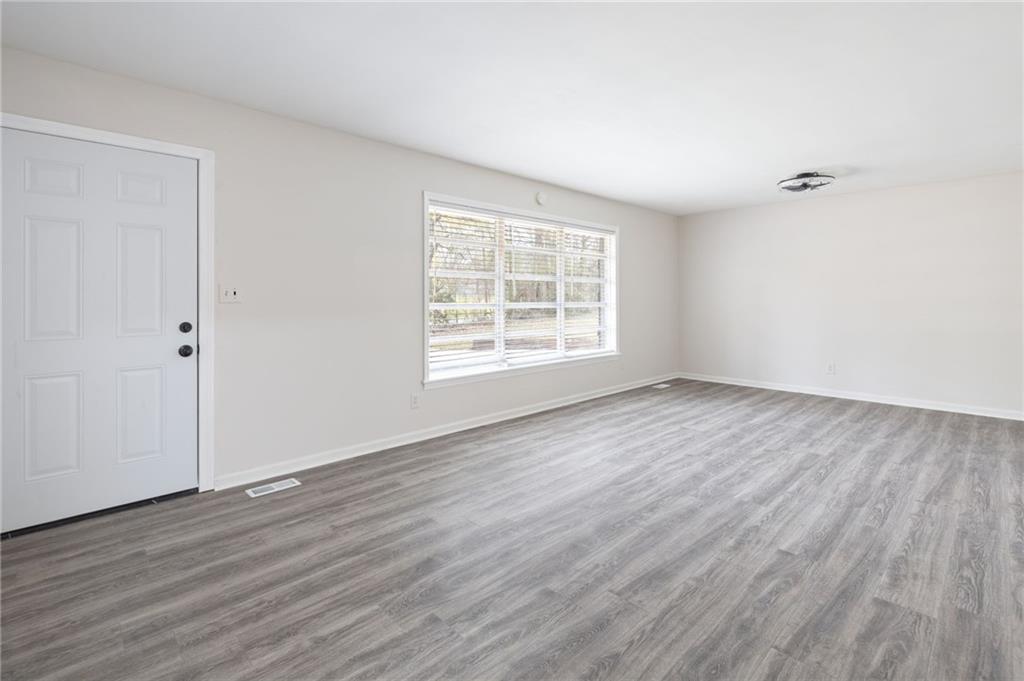 4611 Old Westside Road Austell, GA 30106 - Photo 10 of 37 an empty room with wooden floor and windows