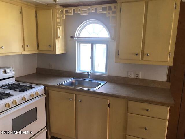 6 D Trail Brick, NJ 08724 - Photo 12 of 31 a kitchen with yellow cabinets and a stove