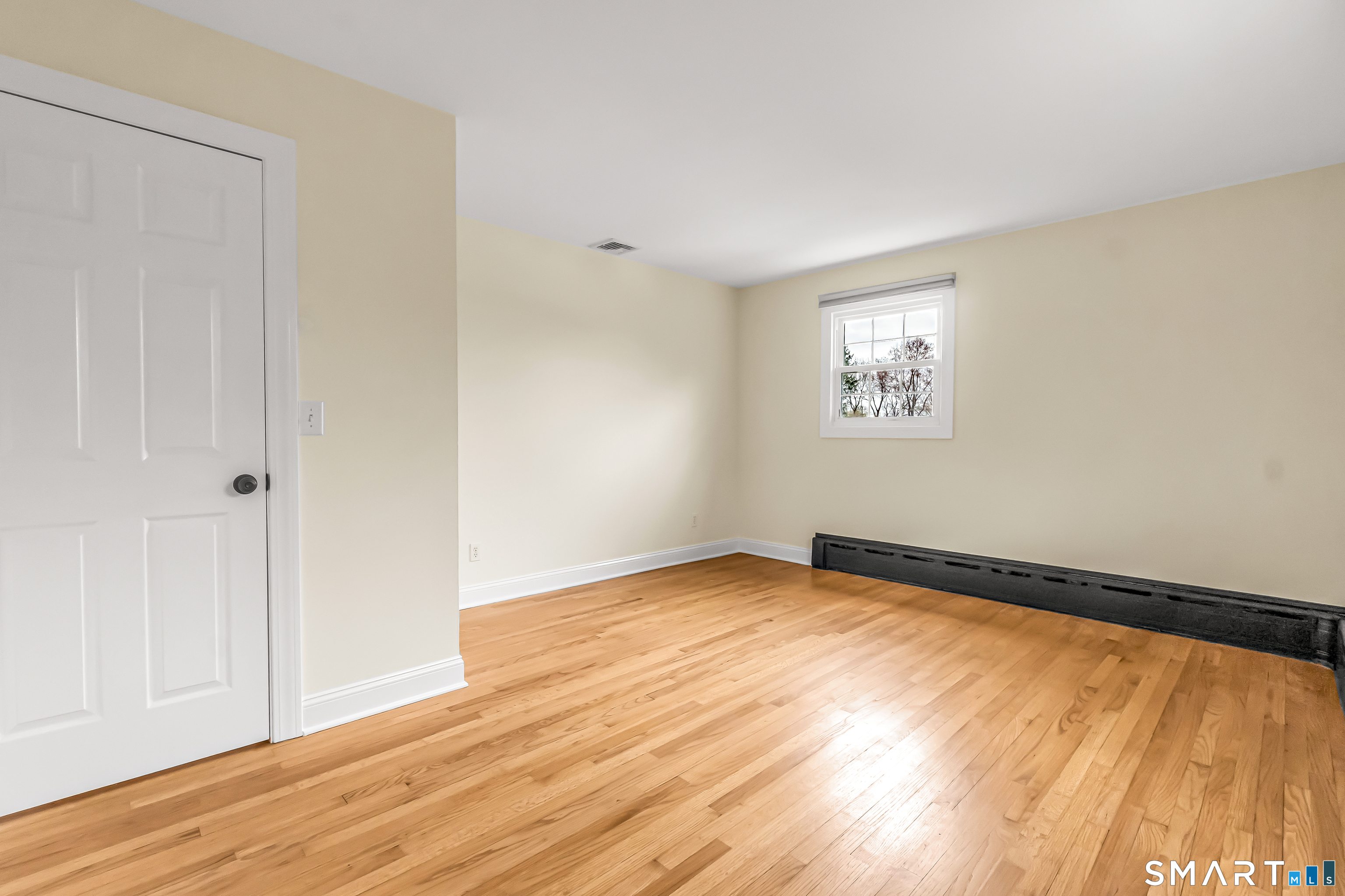 15 Bruns Road Ansonia, CT 06401 - Photo 13 of 39 an empty room with wooden floor and windows