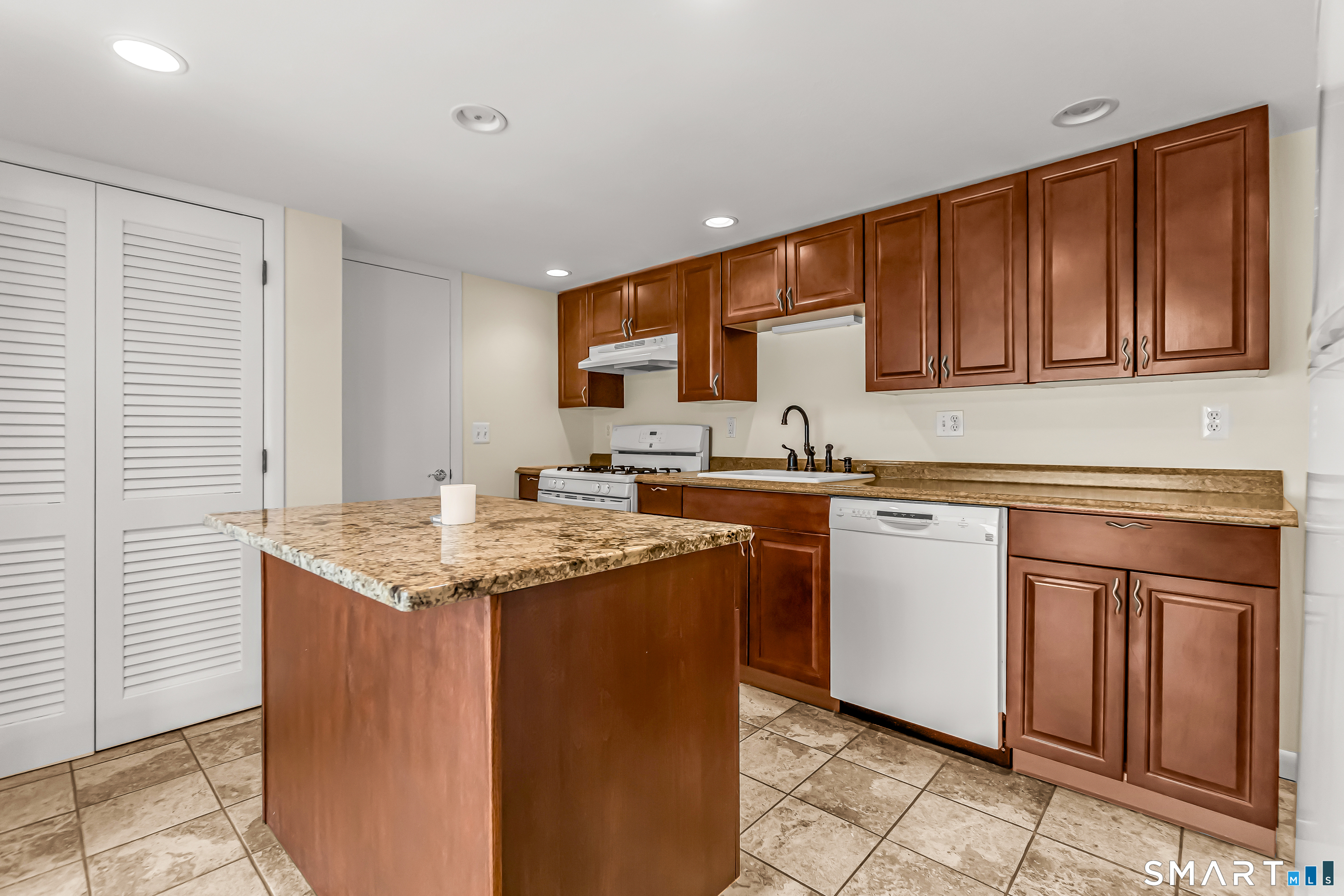 15 Bruns Road Ansonia, CT 06401 - Photo 18 of 39 a kitchen with stainless steel appliances granite countertop a sink stove and cabinets