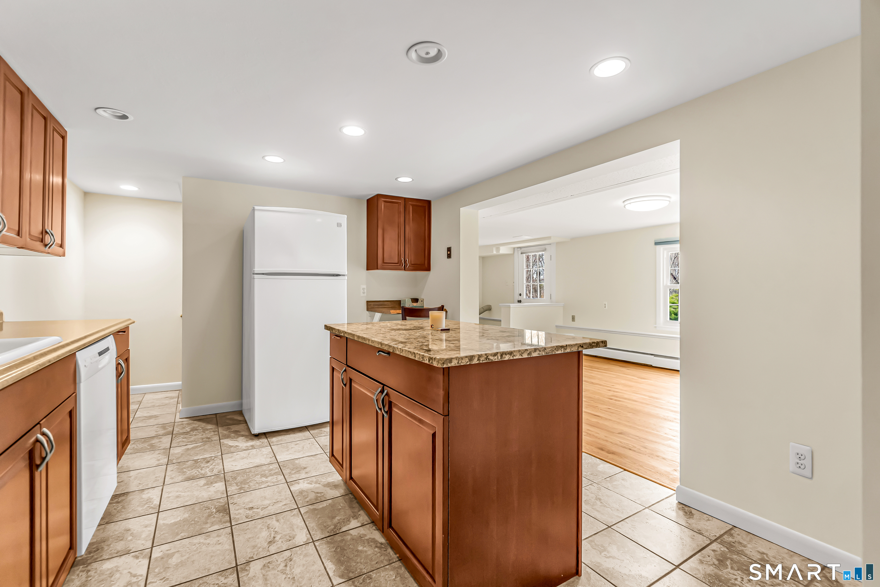 15 Bruns Road Ansonia, CT 06401 - Photo 19 of 39 a kitchen with granite countertop a sink and a stove top oven with wooden floor