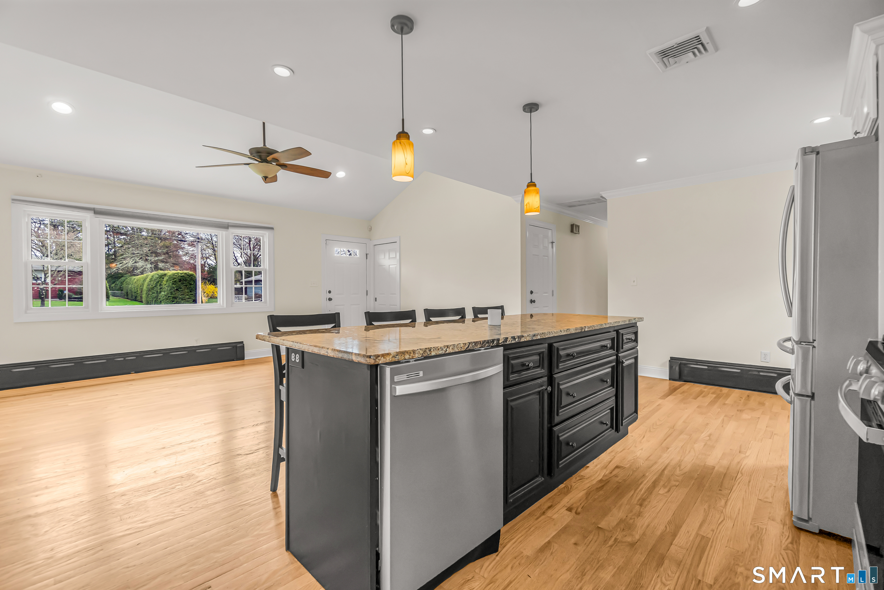 15 Bruns Road Ansonia, CT 06401 - Photo 5 of 39 a kitchen with a stove a sink a center island a refrigerator and a wooden floor