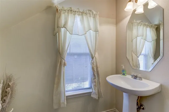 a bathroom with a sink and mirror