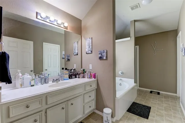 a bathroom with a sink double vanity and a mirror