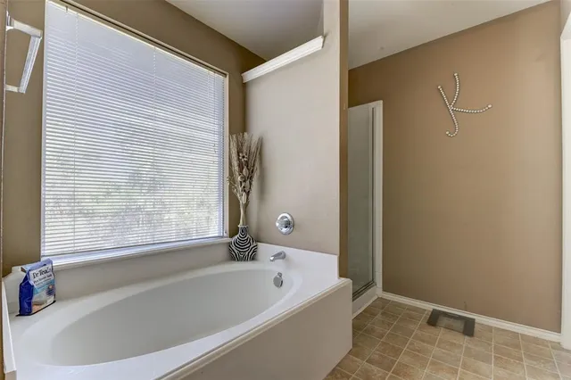 a bathroom with a bathtub and shower