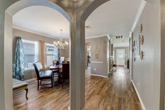 a view of a hallway view with wooden floor and furniture