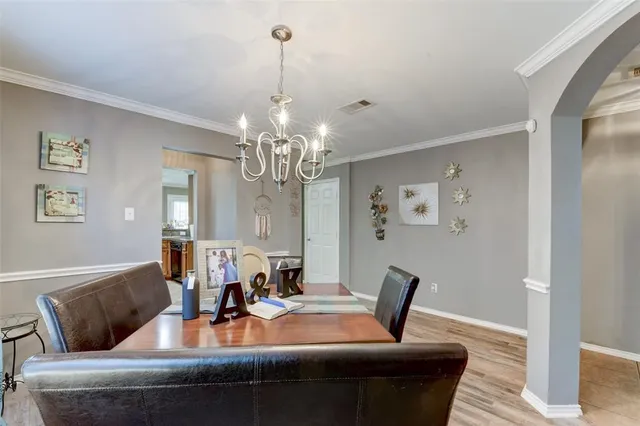 a view of a dining room with furniture and chandelier