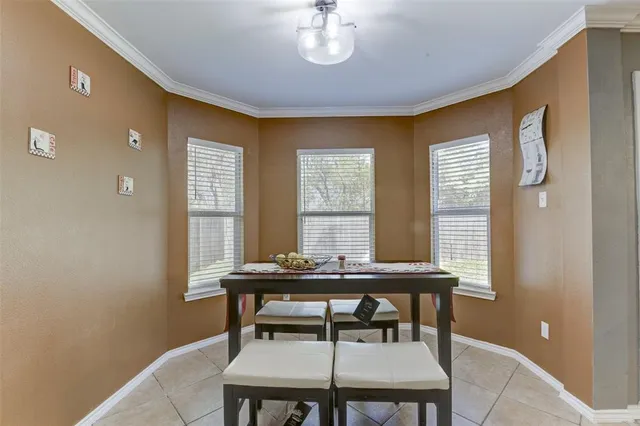 a view of a dining room with furniture and window