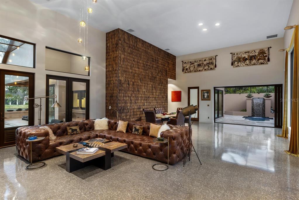 49 Osprey Point Drive Osprey, FL 34229 - Photo 25 of 95 a living room with furniture and large windows