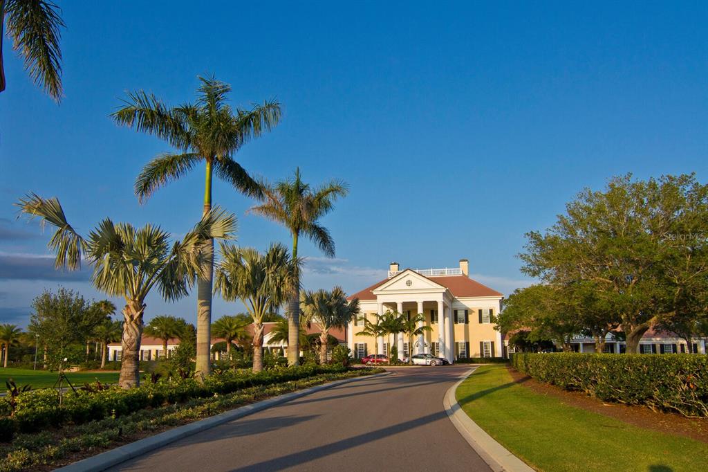 49 Osprey Point Drive Osprey, FL 34229 - Photo 88 of 95 a view of a white house with a fountain and a palm tree