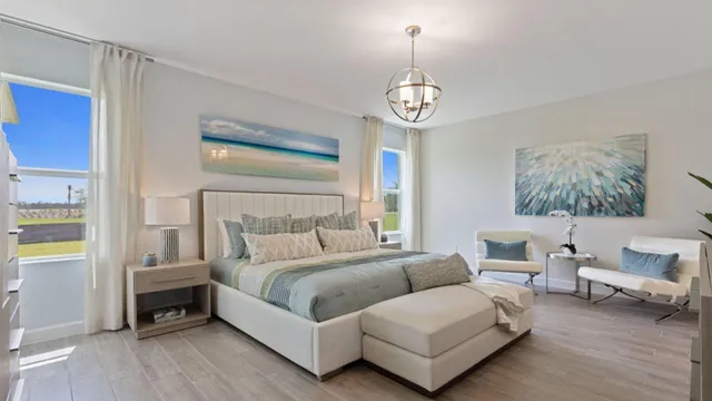 a spacious bedroom with a bed and a chandelier