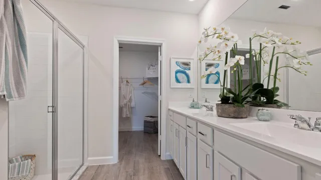 a bathroom with a sink and mirror with toilet