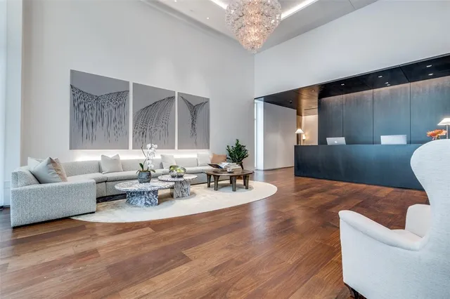 a living room with furniture and a chandelier