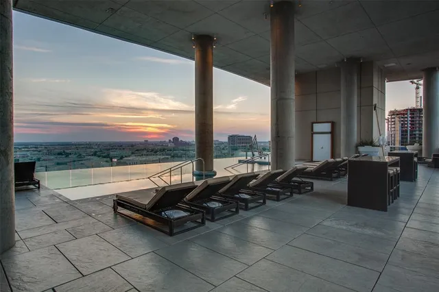 a living room with patio furniture and a floor to ceiling window