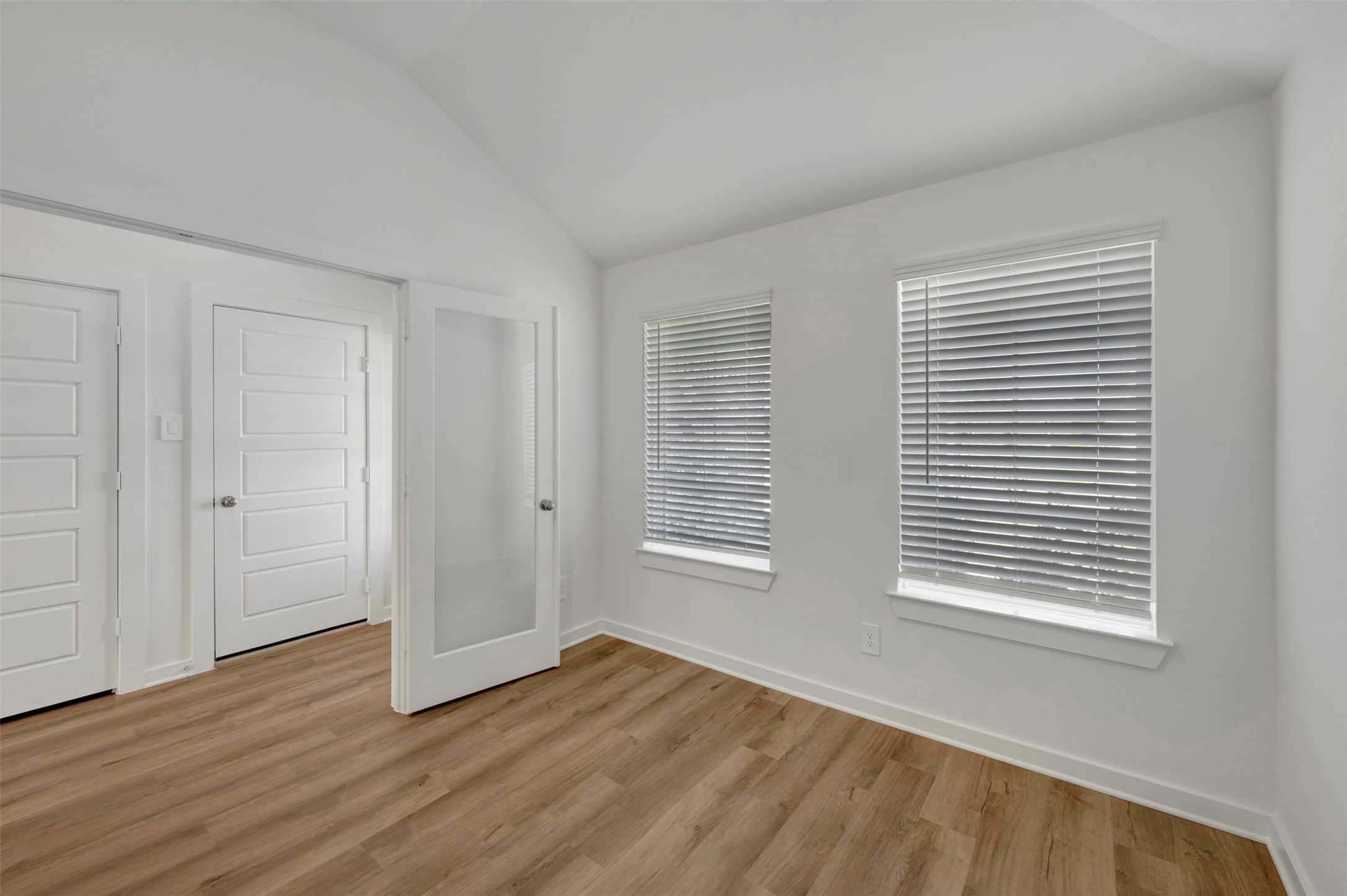 716 Hackberry Branch Magnolia, TX 77354 - Photo 13 of 32 a view of an empty room with wooden floor and a window