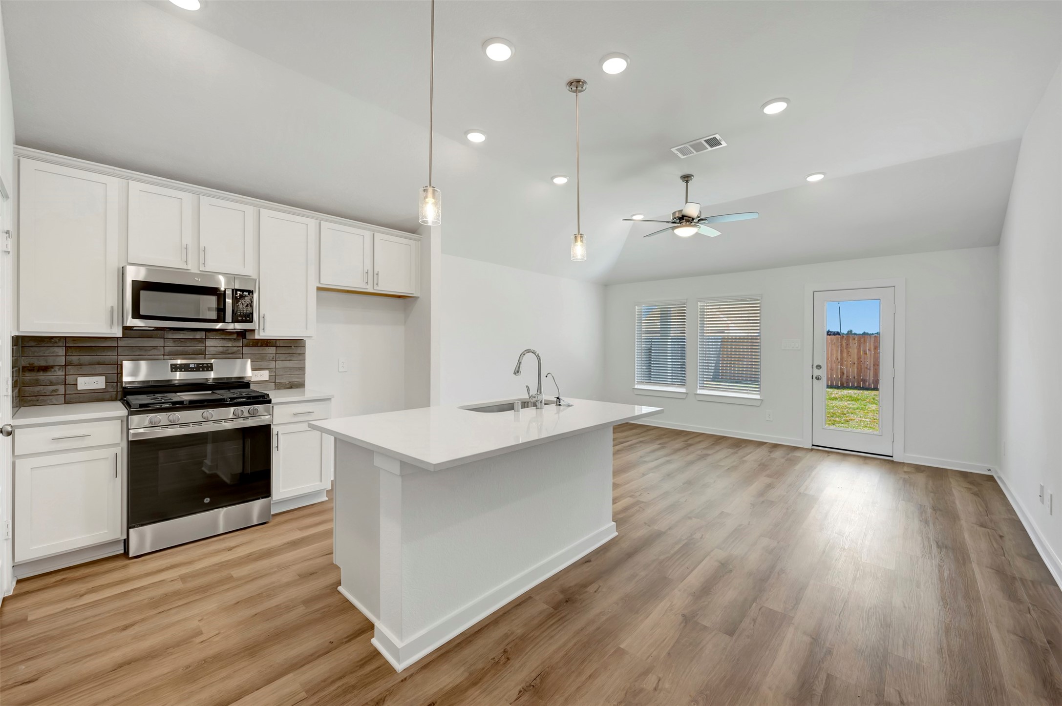 716 Hackberry Branch Magnolia, TX 77354 - Photo 20 of 32 a large kitchen with cabinets wooden floor and stainless steel appliances