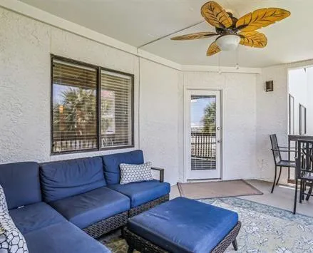 a living room with furniture a rug and a chandelier