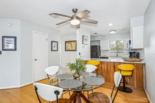 a dining room with furniture a window and wooden floor