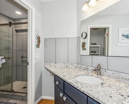7453 Sunset Harbor Drive, Unit 2203 Navarre, FL 32566 - Photo 10 of 21 a bathroom with a granite countertop sink and a mirror