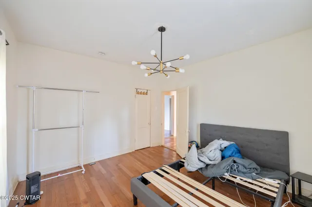 a bedroom with bed and window