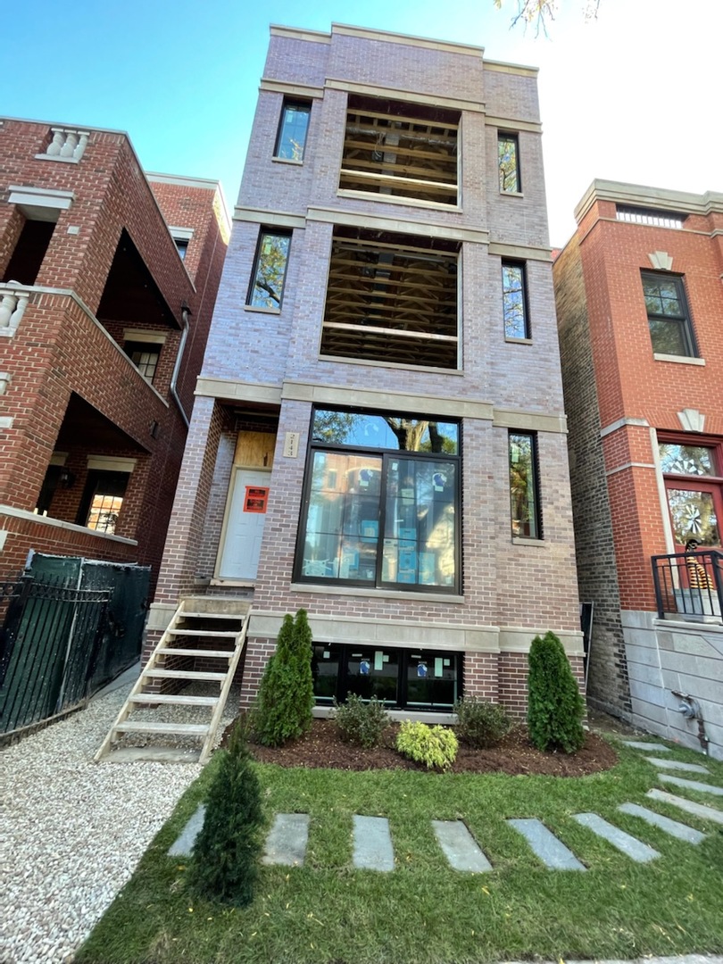 2143 North Racine Avenue, Unit 1 Chicago, IL 60614 - Photo 1 of 10 a front view of a house with a yard