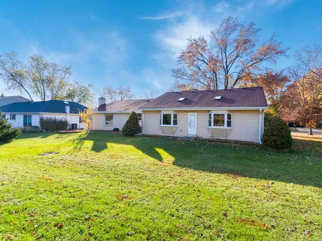 a view of a house with pool and a yard