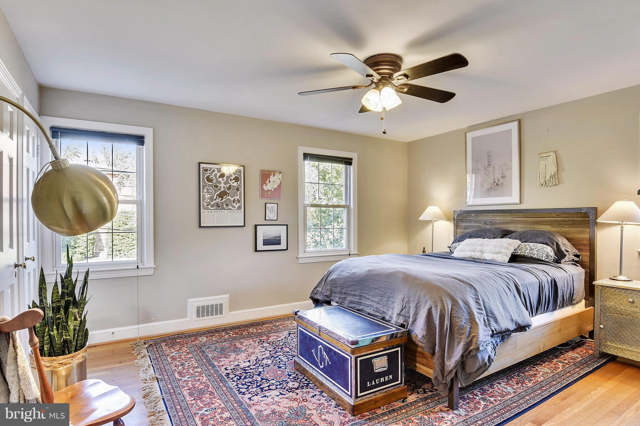 624 Wayne Avenue Silver Spring, MD 20910 - Photo 16 of 28 a bedroom with a bed a window and a chandelier