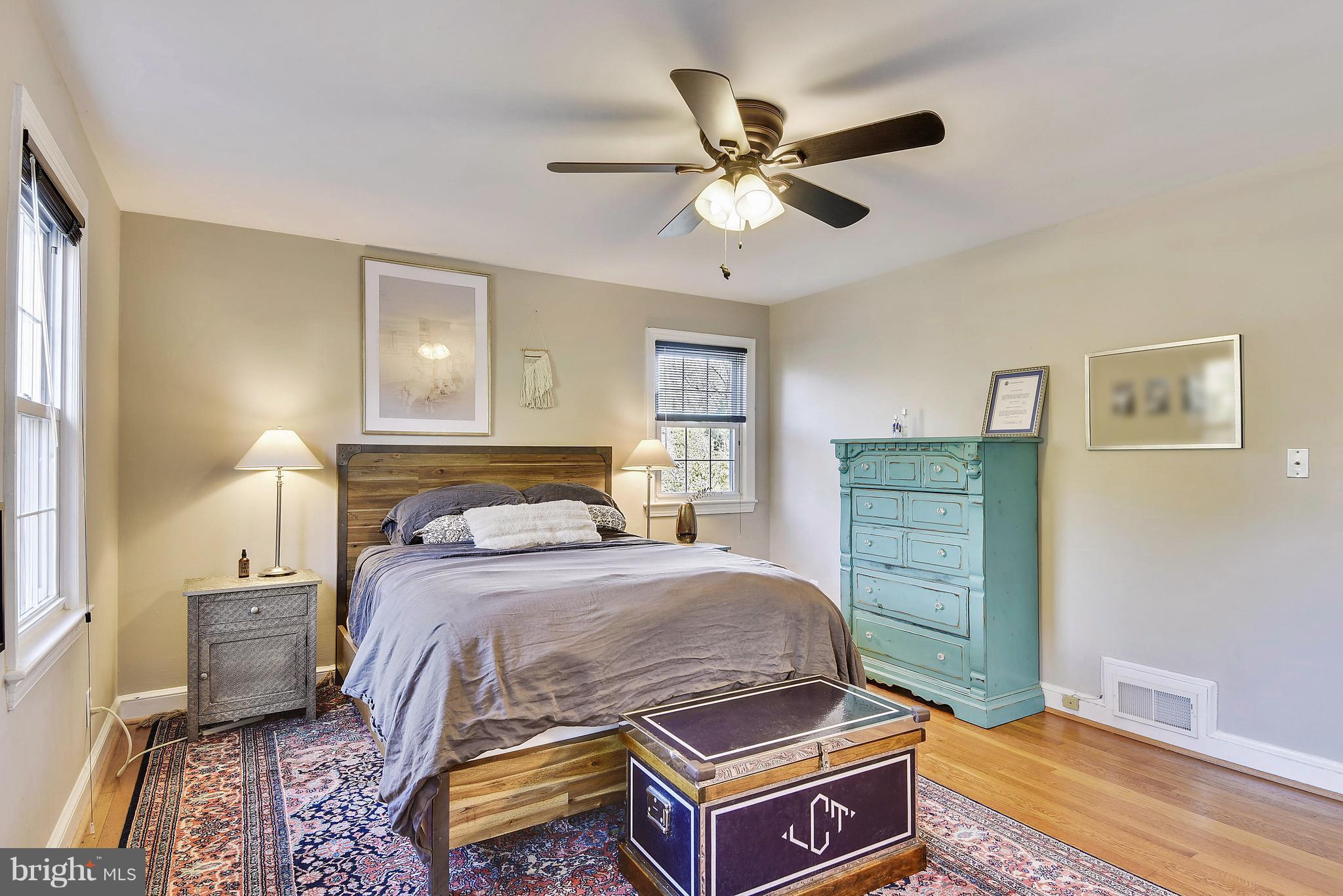 624 Wayne Avenue Silver Spring, MD 20910 - Photo 17 of 28 a bedroom with a bed and a chandelier