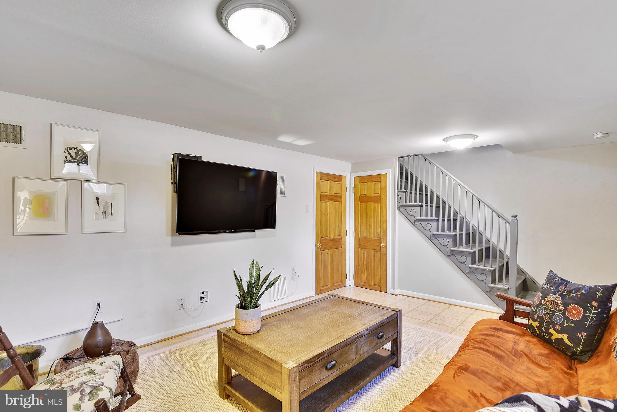 624 Wayne Avenue Silver Spring, MD 20910 - Photo 22 of 28 a living room with furniture and a flat screen tv