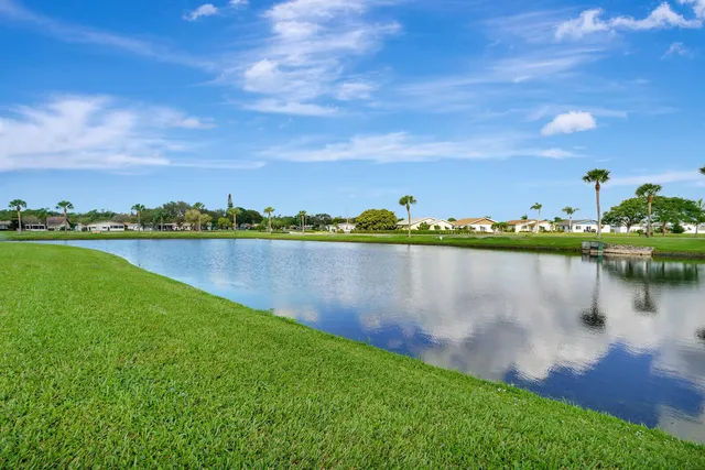 a view of a lake with houses in the back