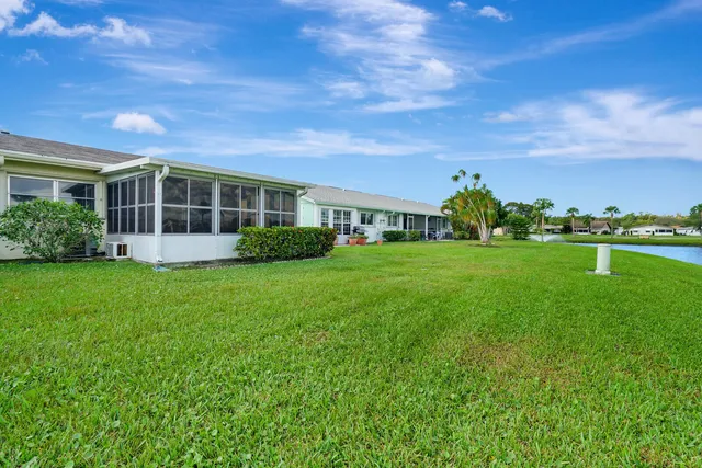 a view of a house with yard and sitting area