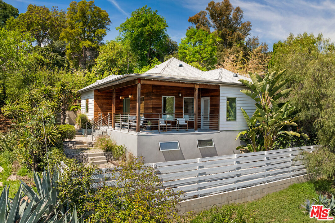 a view of house with yard outdoor seating and green space