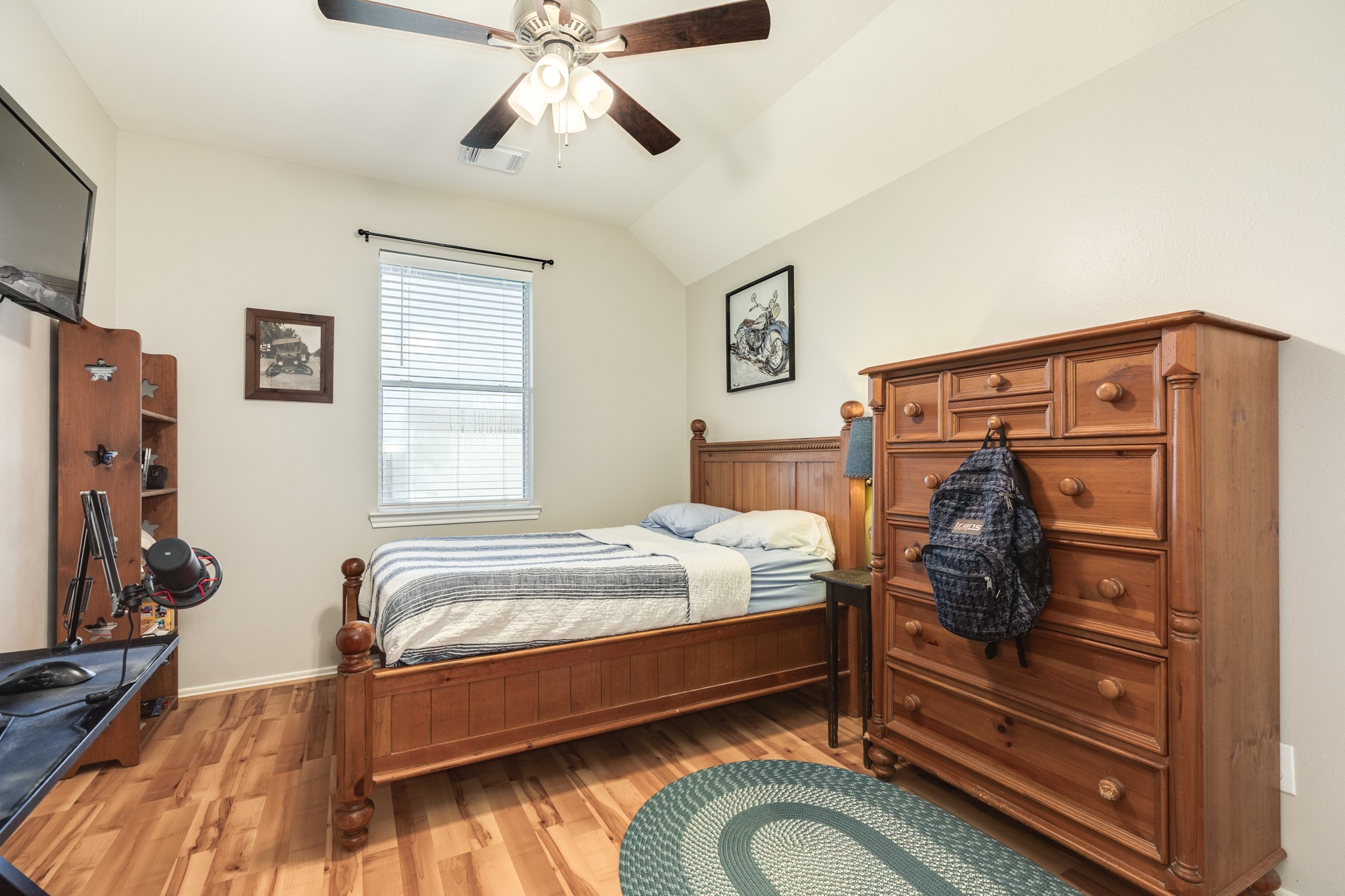 13808 Stark Bridge Lane Rosharon, TX 77583 - Photo 21 of 39 Secondary bedroom features beautiful new laminate flooring, a freshly painted window overlooking the backyard, and a modern ceiling fan.
