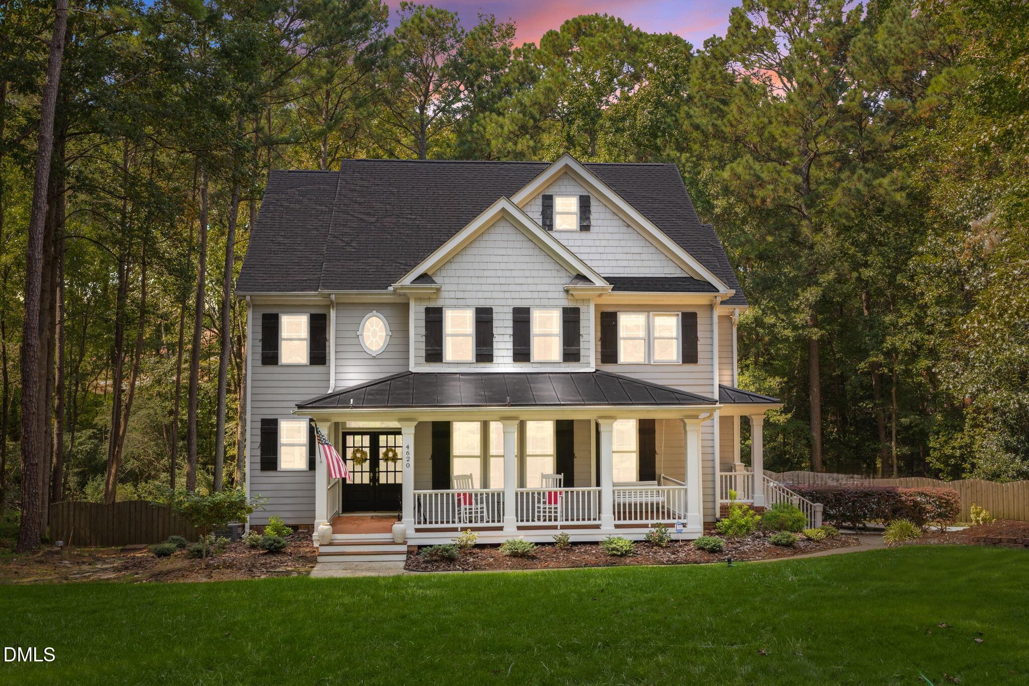 a front view of a house with a yard table and chairs