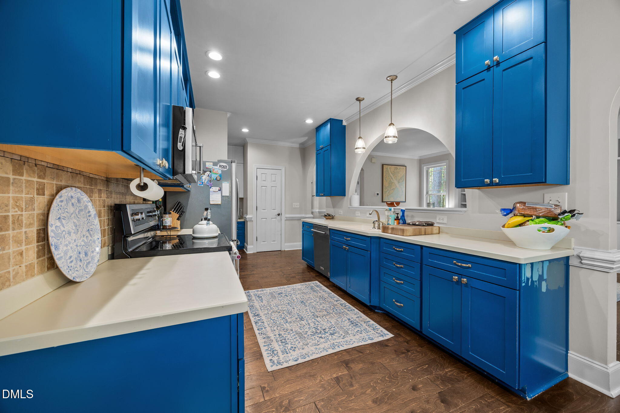4620 Cresta Drive Raleigh, NC 27603 - Photo 12 of 39 a kitchen with kitchen island granite countertop a sink a stove and a wooden cabinets