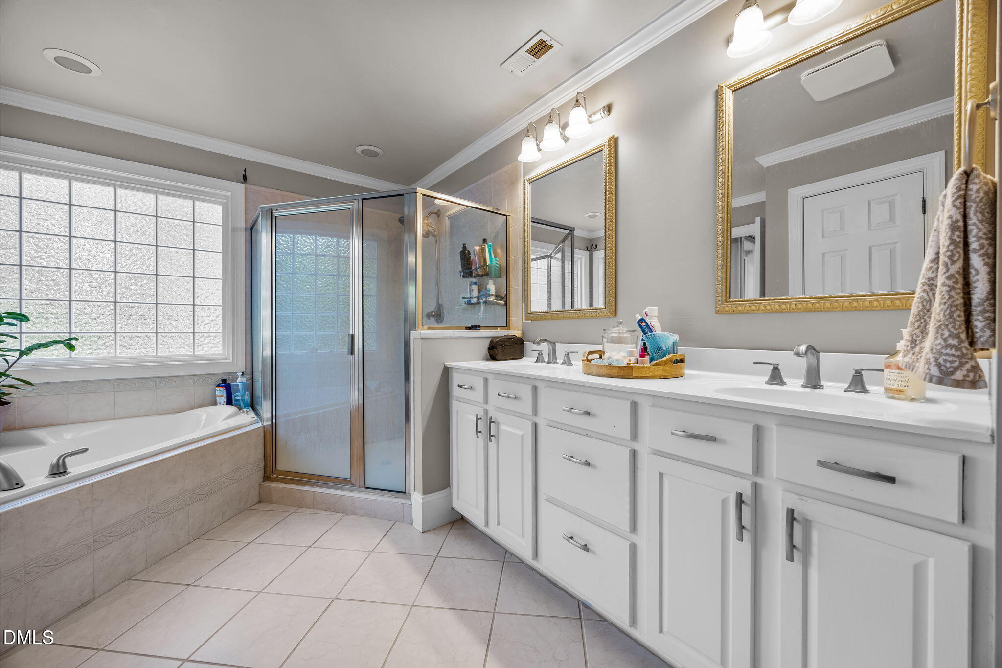 4620 Cresta Drive Raleigh, NC 27603 - Photo 18 of 39 a bathroom with a double vanity sink mirror double and bathtub