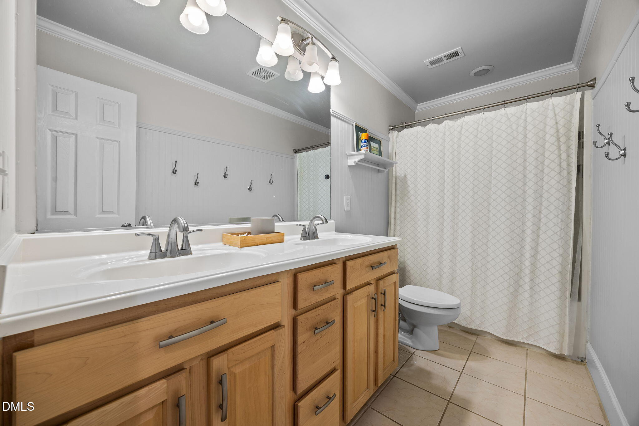 4620 Cresta Drive Raleigh, NC 27603 - Photo 21 of 39 a bathroom with a sink a toilet and a mirror