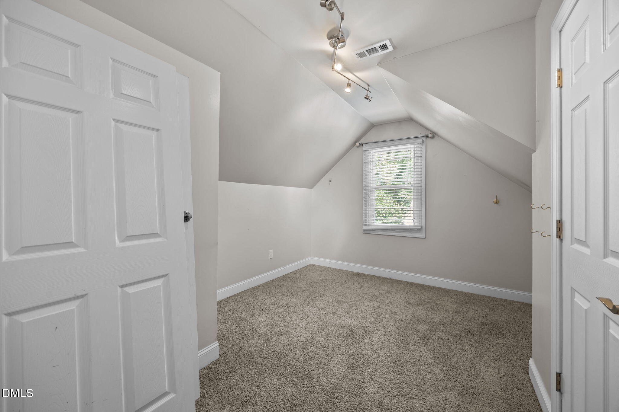 4620 Cresta Drive Raleigh, NC 27603 - Photo 26 of 39 an empty room with windows and fan
