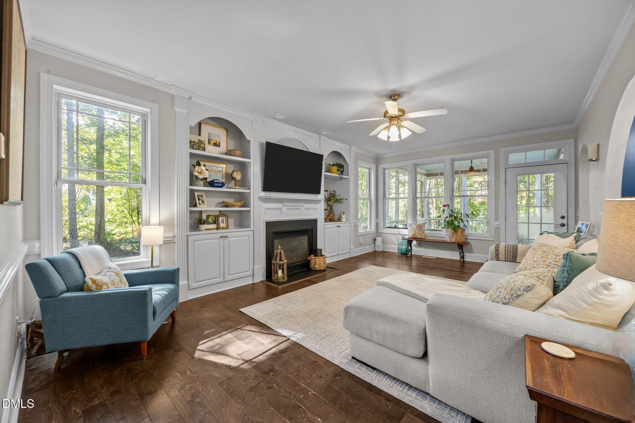 4620 Cresta Drive Raleigh, NC 27603 - Photo 8 of 39 a living room with furniture a fireplace and a flat screen tv