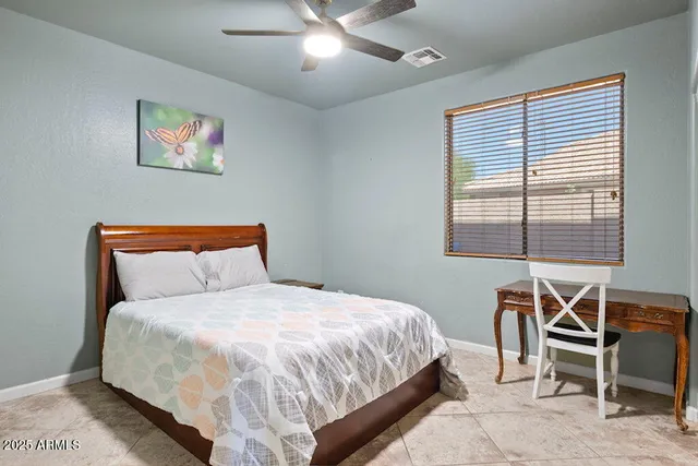 a bedroom with a bed and a table