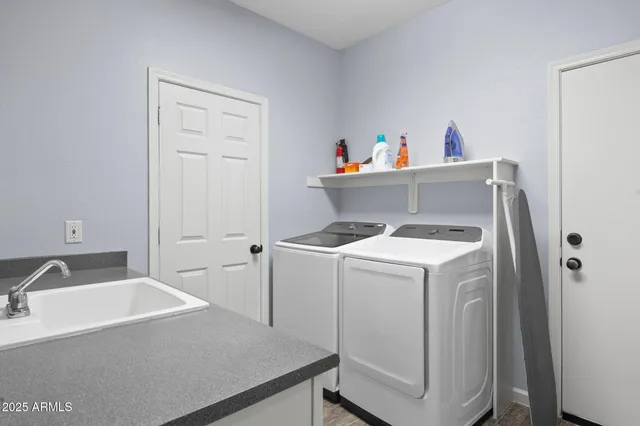 a bedroom with a bed and a flat tv screen on dresser