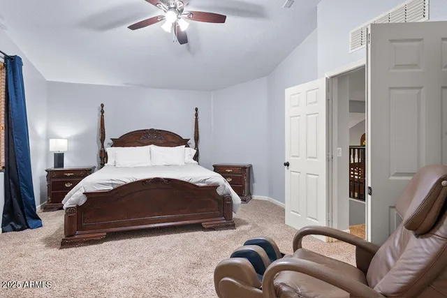 a bedroom with a bed and a television